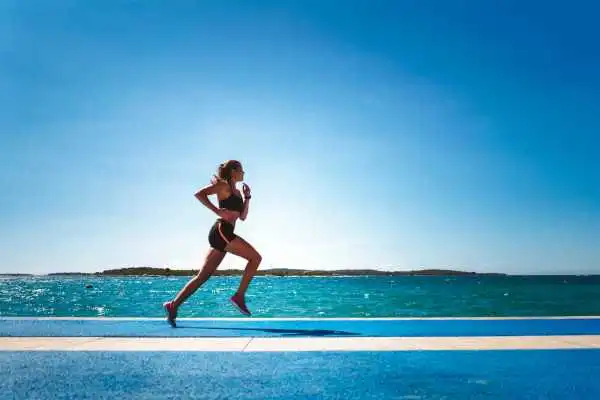 Woman running showing strong leg muscle Ascot
